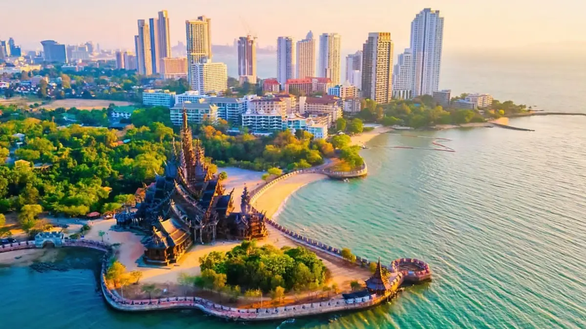 scenic view of Pattaya Beach with golden sand, blue sea, and beach activities in pattaya
